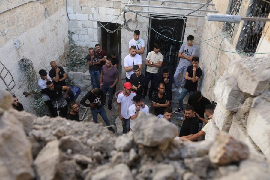 People gather at the scene where two Palestinian militants were killed during clashes with Israeli forces in a raid, in Nablus in the Israeli-occupied West Bank, July 24, 2022. REUTERS/Raneen Sawafta