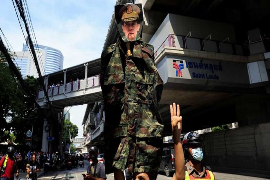 A person holds a picture of Senior General Min Aung Hlaing as demonstrators protest against the execution of pro-democracy activists, at Myanmar embassy in Bangkok, Thailand Jul 26, 2022.REUTERS