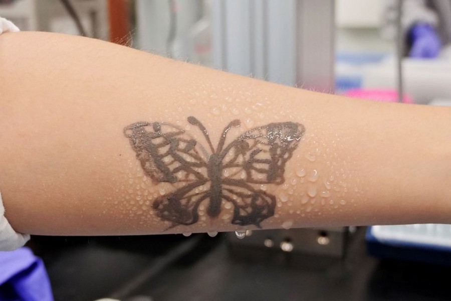 Water sprays on arm are seen with an electronic tattoo (e-tattoo) for the wettability test at the Korea Advanced Institute of Science and Technology (KAIST) in Daejeon, South Korea, July 26, 2022. REUTERS/Minwoo Park