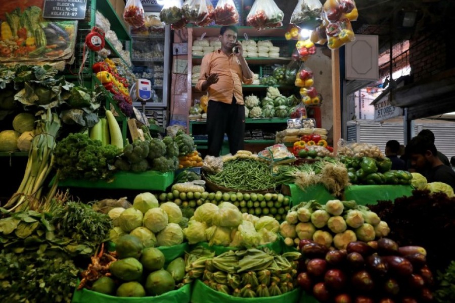 A vegetable vendor speaks on his mobile phone at a retail market area in Kolkata, India, March 22, 2022.REUTERS