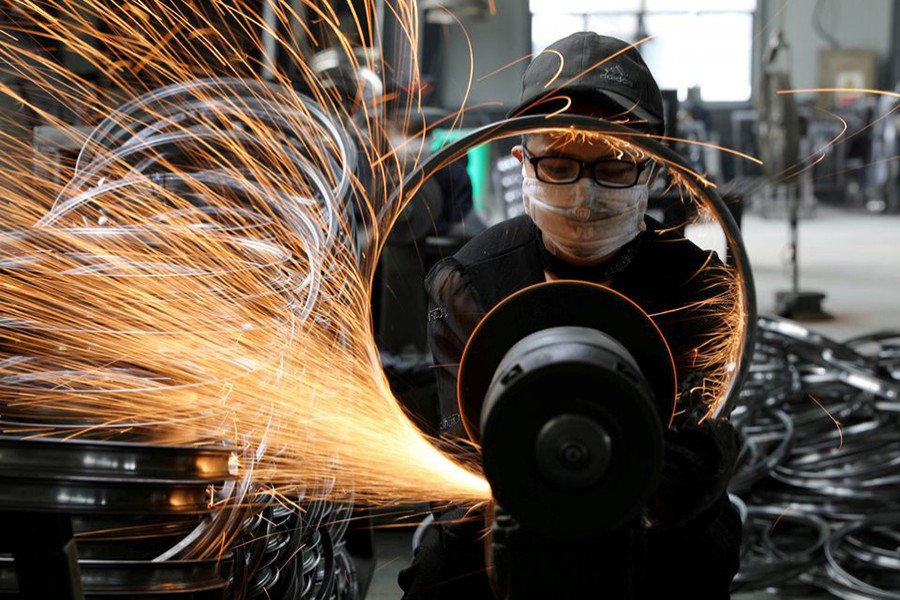 A worker welds a bicycle steel rim at a factory manufacturing sports equipment in Hangzhou, Zhejiang province, China on September 2, 2019 — China Daily via REUTERS/Files