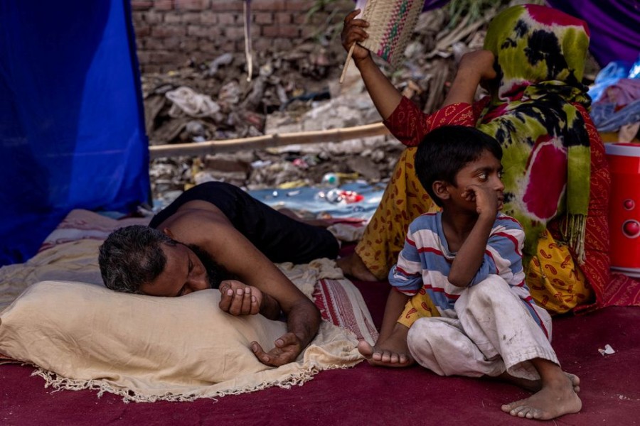 A Rohingya refugee family rests in a temporary shelter after a fire destroyed a Rohingya refugee camp on Saturday night, in New Delhi, India, June 14, 2021. REUTERS/Danish Siddiqui