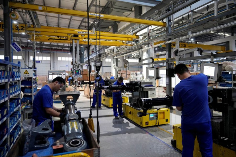 Employees work on the production line of vehicle components during a government-organised media tour to a factory of German engineering group Voith, following the coronavirus disease (COVID-19) outbreak, in Shanghai, China July 21, 2022. REUTERS/Aly Song