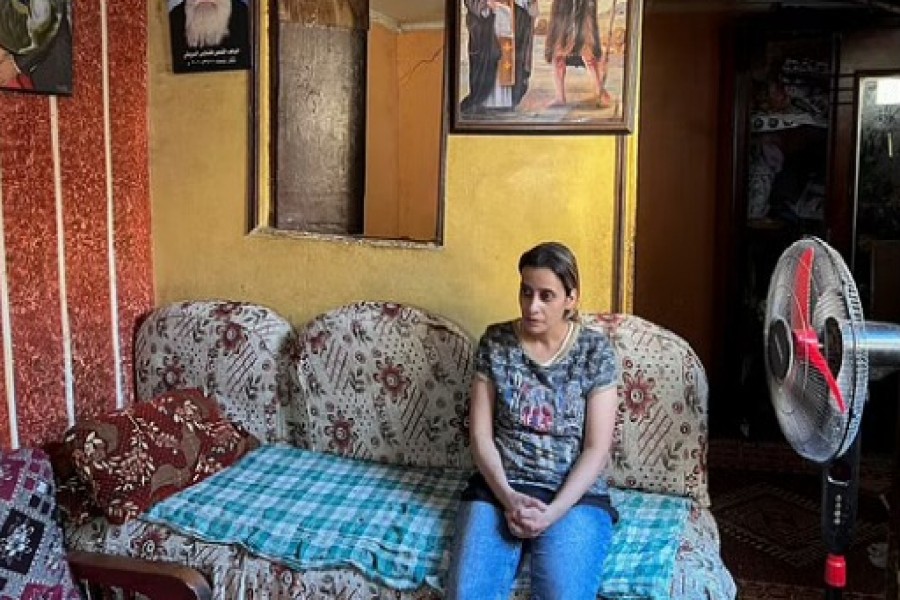 Mary Magdy, a Coptic Christian woman, speaks during an interview with Reuters TV, at her home in Cairo, Egypt Jul 7, 2022. REUTERS