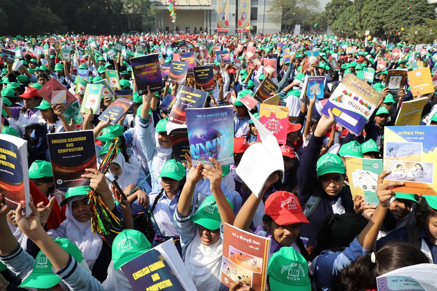 Students burst into joy after having the new text books in Dhaka. Quality of education in Bangladesh faces various challenges. 	—FE File Photo