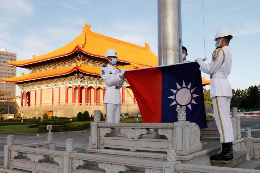 Honour guard members take part in a Taiwanese flag-raising ceremony at Chiang Kai-shek Memorial Hall in Taipei, Taiwan on August 6, 2022 [File: Jameson Wu/Reuters]