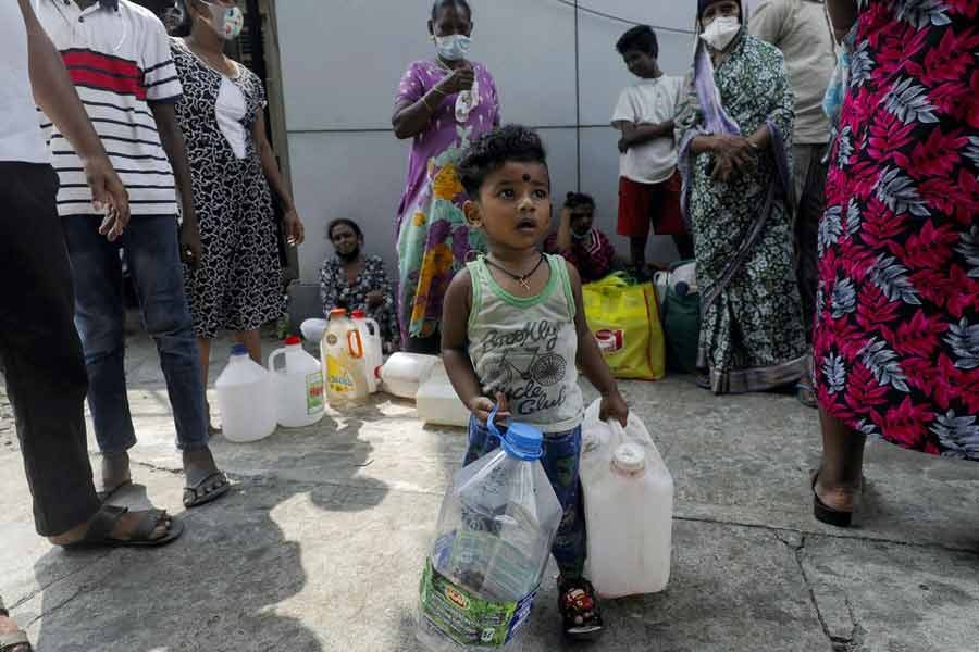 A child waiting to buy kerosene with his mother in the morning plays with cans at a fuel station in Colombo of Sri Lanka on March 18 this year amid a shortage of domestic gas due to the country's economic crisis –Reuters file photo