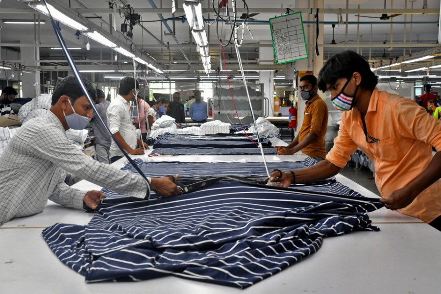 Garment workers cut fabric to make shirts at a textile factory of Texport Industries in Hindupur town in the southern state of Andhra Pradesh, India, February 9, 2022. REUTERS/Samuel Rajkumar