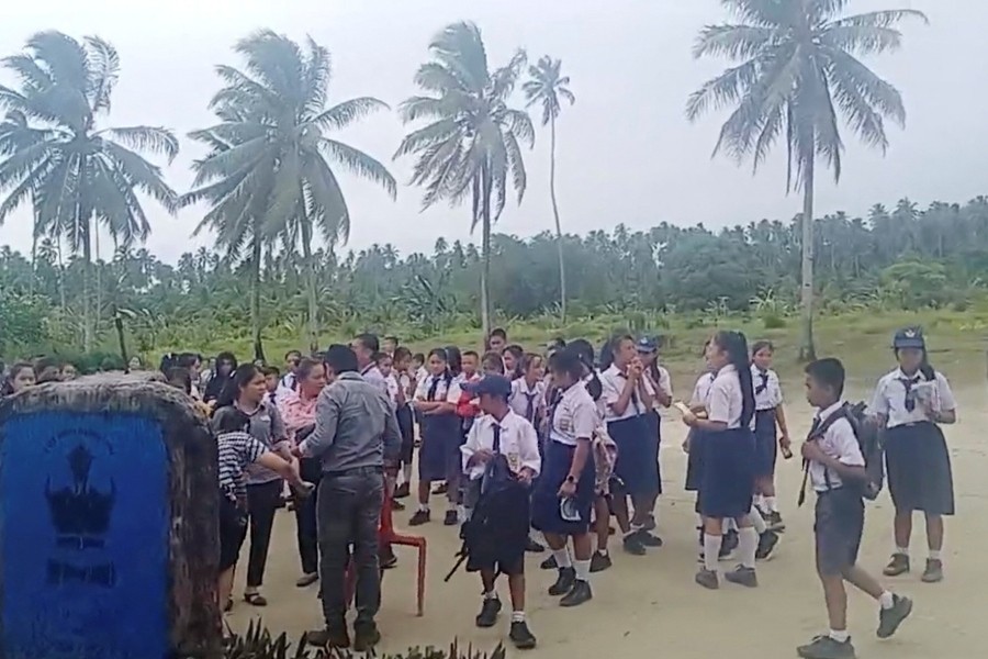 School students and staff gather in an open area after a magnitude 6.4 earthquake struck near Mentawai Islands, in South Nias, North Sumatra, Indonesia Aug 29, 2022 in this screen grab obtained from a social media video. Facebook/Doniman Aro Harefa/via REUTERS