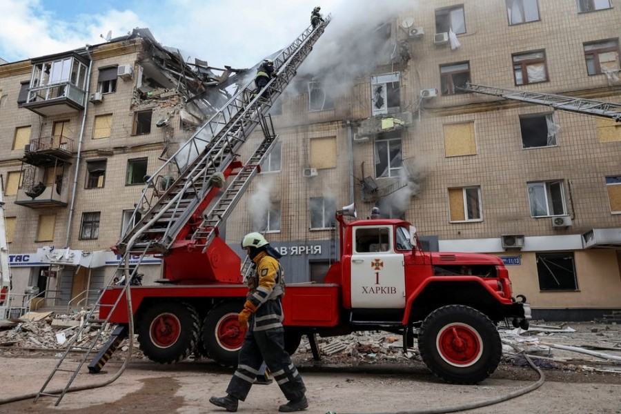 Firefighters work at the site of a residential building hit by a Russian military strike, amid Russia's attack on Ukraine, in Kharkiv, Ukraine September 6, 2022. REUTERS/Sofiia Gatilova/File Photo