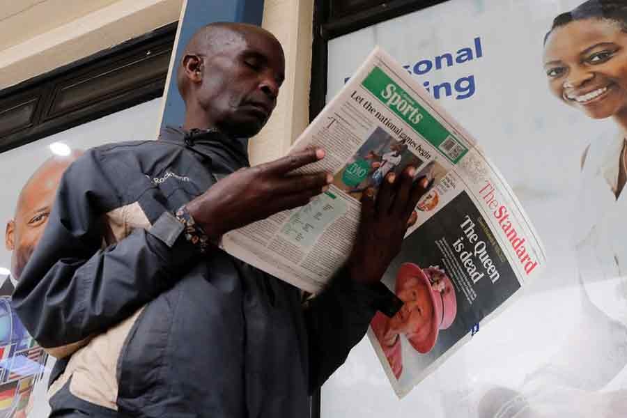 A man reading a newspaper reporting on the death of Queen Elizabeth, Britain's longest-reigning monarch, in Nairobi of Kenya on September 9 this year –Reuters file photo
