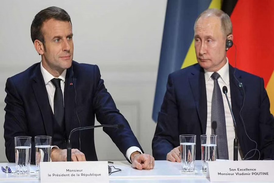 French President Emmanuel Macron and Russian President Vladimir Putin give a press conference after a summit on Ukraine at the Elysee Palace in Paris, December 9, 2019. REUTERS