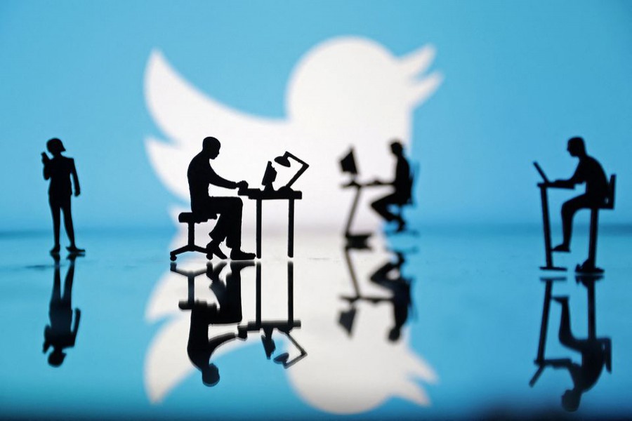 Figurines with computers and smartphones are seen in front of Twitter logo in this illustration on July 24, 2022 — Reuters/Files