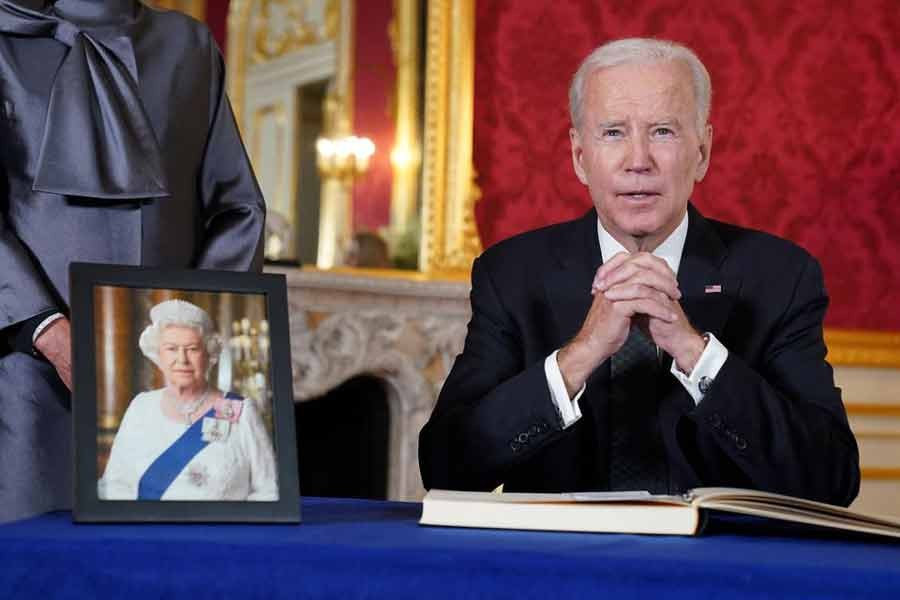 US President Joe Biden attending to sign a condolence book for Britain's Queen Elizabeth, following her death, at Lancaster House in London on Sunday –Reuters file photo