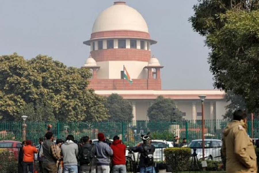 Television journalists are seen outside the premises of the Supreme Court in New Delhi, India, Jan 22, 2020. REUTERS