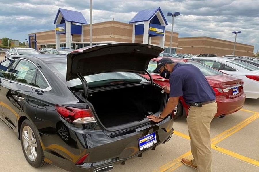 Brandon Parrum, general manager of CarMax's Des Moines store, shows off one of the many vehicles that customers can arrange to buy online and collect at the store using "contactless" curbside pickup, a service the US used car retailer launched during the coronavirus disease (COVID-19) pandemic, in De Moines, Iowa, US July 29, 2020. REUTERS