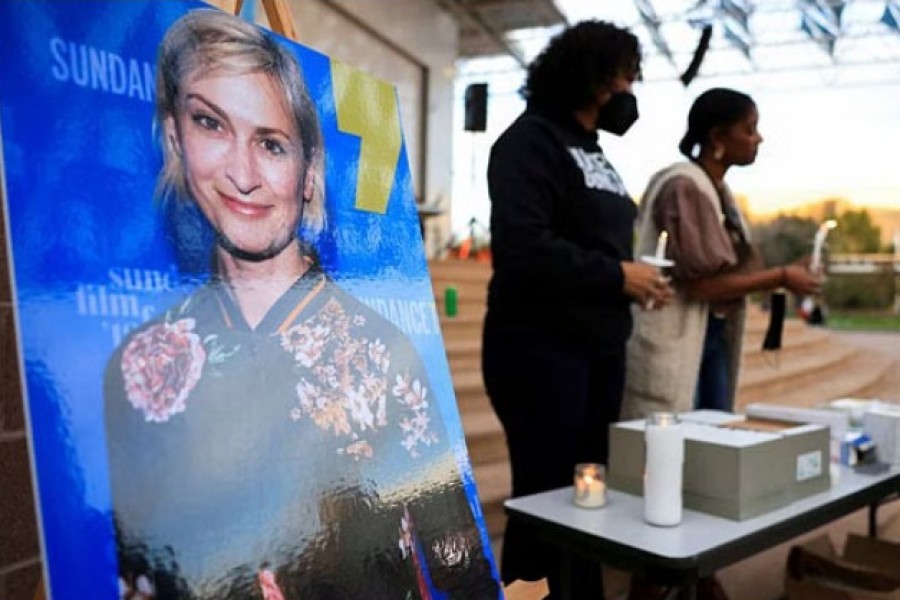 An image of cinematographer Halyna Hutchins, who died after being shot by Alec Baldwin on the set of his movie "Rust", is displayed at a vigil in her honour in Albuquerque, New Mexico, US, October 23, 2021. REUTERS/Kevin Mohatt/File Photo