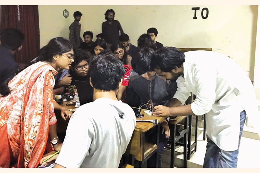 Participants observing their instructor's demonstration at 'Introduction to Robotics' workshop arranged by RoboSust, a research-based robotics club of Shahjalal University of Science and Technology