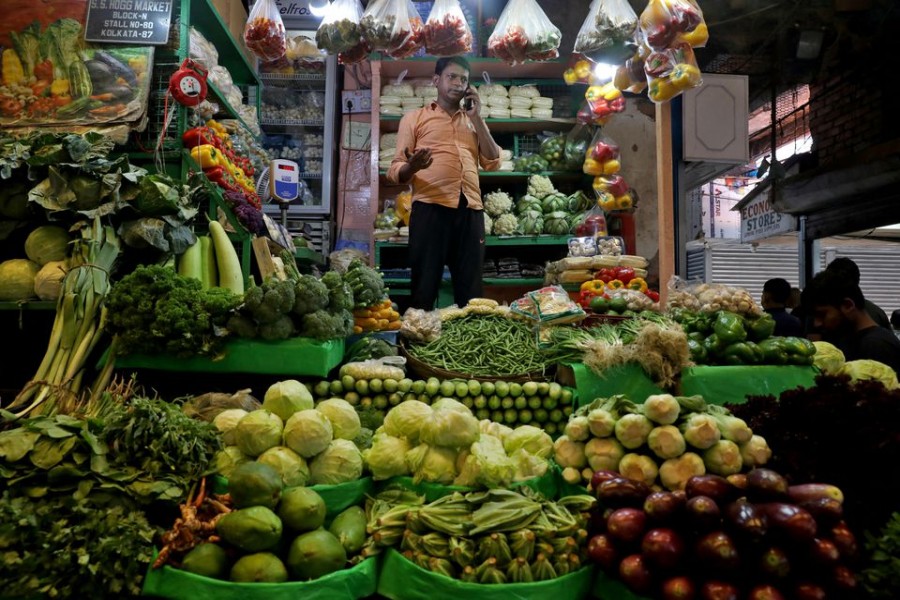 Debashis Dhara, a vegetable vendor, speaks on his mobile phone at a retail market area in Kolkata, India, March 22, 2022. Picture taken March 22, 2022. REUTERS/Rupak De Chowdhuri/File Photo