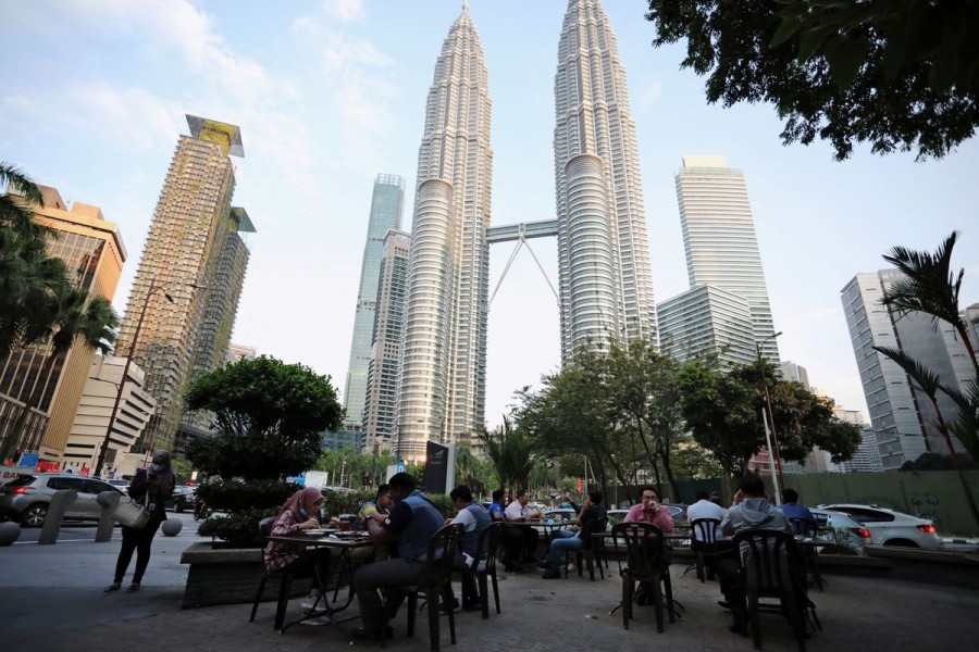 People dine in at a restaurant in front of Petronas Twin Towers, in Kuala Lumpur, Malaysia November 5, 2020. Picture taken November 5, 2020. REUTERS/Lim Huey Teng