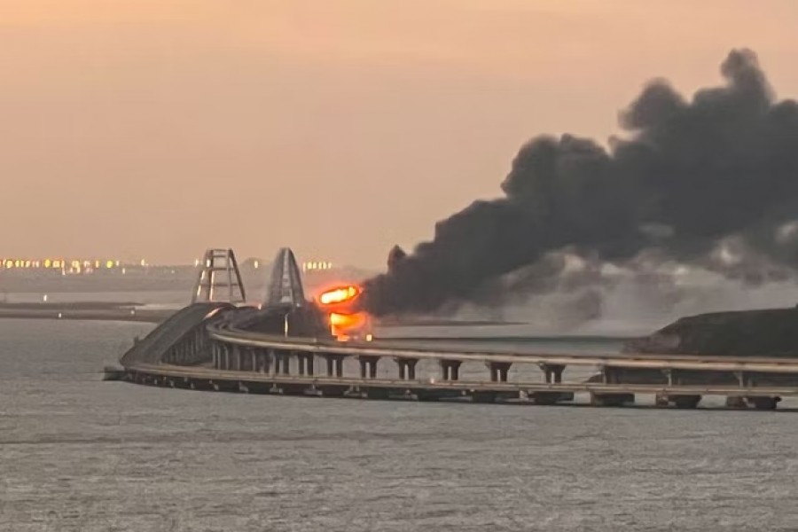 A view shows a fire on the Kerch bridge at sunrise in the Kerch Strait, Crimea, October 8, 2022. Reuters