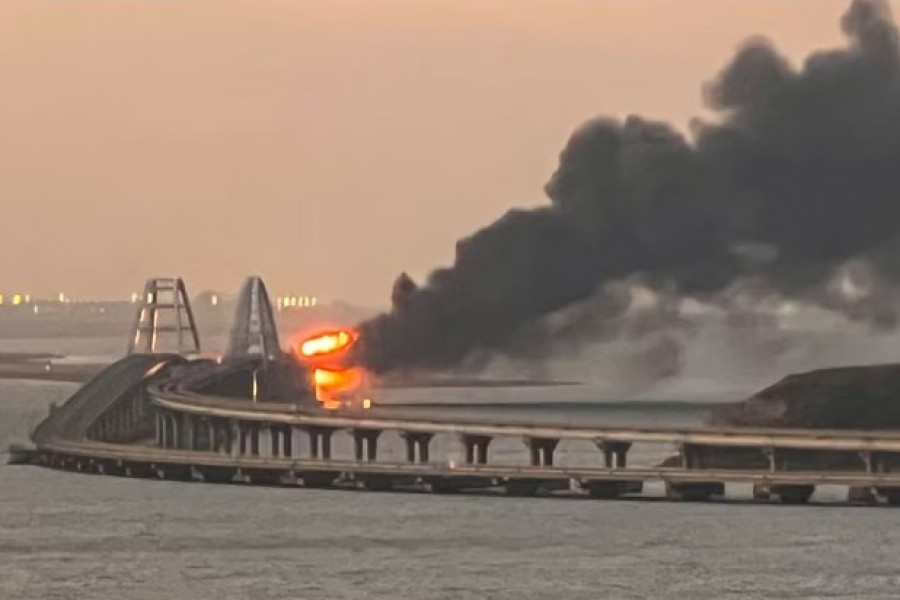 A view shows a fire on the Kerch bridge at sunrise in the Kerch Strait, Crimea, October 8, 2022. Reuters
