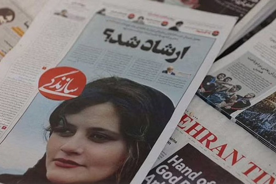 A newspaper with a cover picture of Mahsa Amini, a woman who died after being arrested by Iranian morality police is seen in Tehran, Iran, Sept 18, 2022