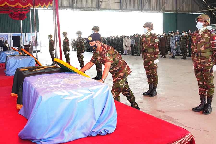 Army Chief General SM Shafiuddin Ahmed paying homage to three United Nations (UN) peacekeepers, who were killed in an explosion during their routine patrolling in the Central African Republic on October 5 last, by placing a wreath at their coffin at Dhaka Cantonment on Saturday –ISPR Photo