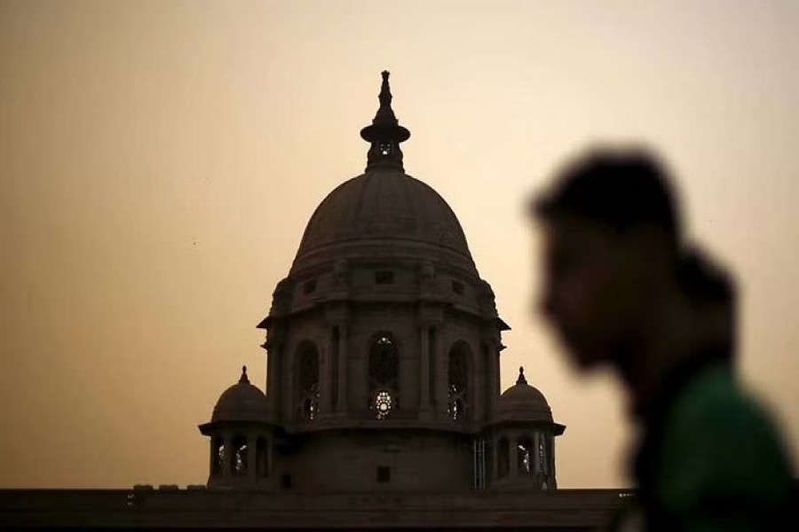 A commuter walks past the building of India's Ministry of Finance during dusk in New Delhi, India, May 18, 2015. India's Finance Ministry could have sidestepped a damaging multibillion-dollar tax row with foreign investors if it had acted on regular warning letters that officials had been sending since as long ago as September. REUTERS