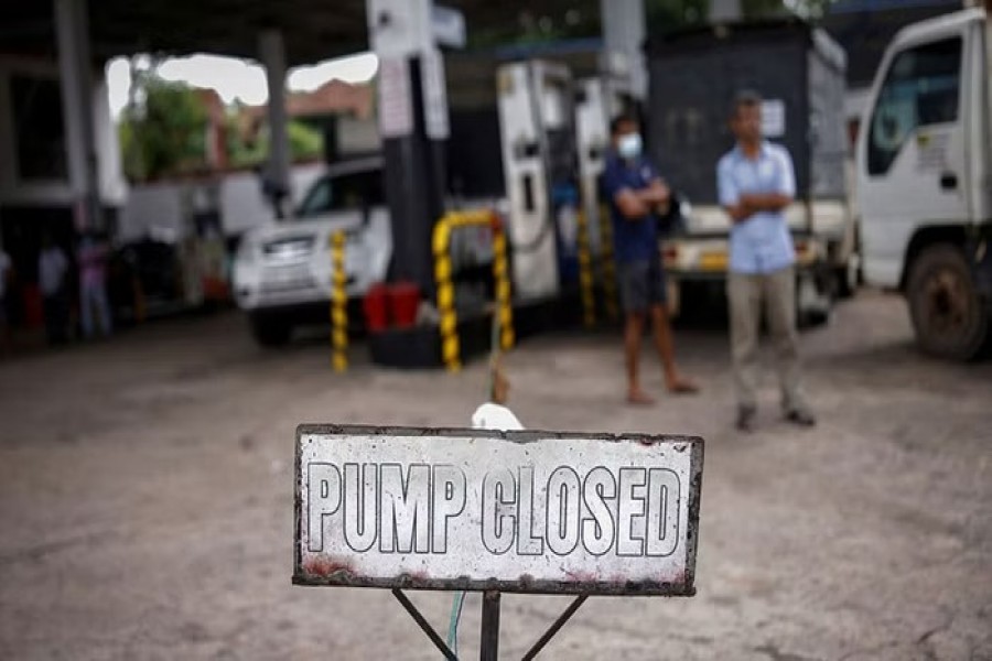 People wait in a queue to buy petrol at a closed fuel station, amid the country's economic crisis in Colombo, Sri Lanka, May 16, 2022. REUTERS/Adnan Abidi