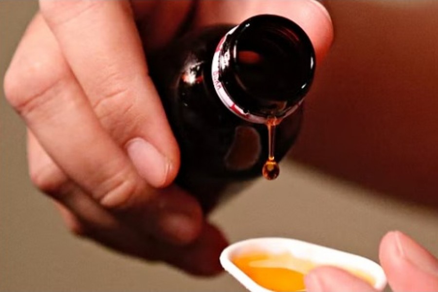 A cough medication is poured in this picture illustration taken Oct 19, 2022. REUTERS/Ajeng Dinar Ulfiana/Illustration