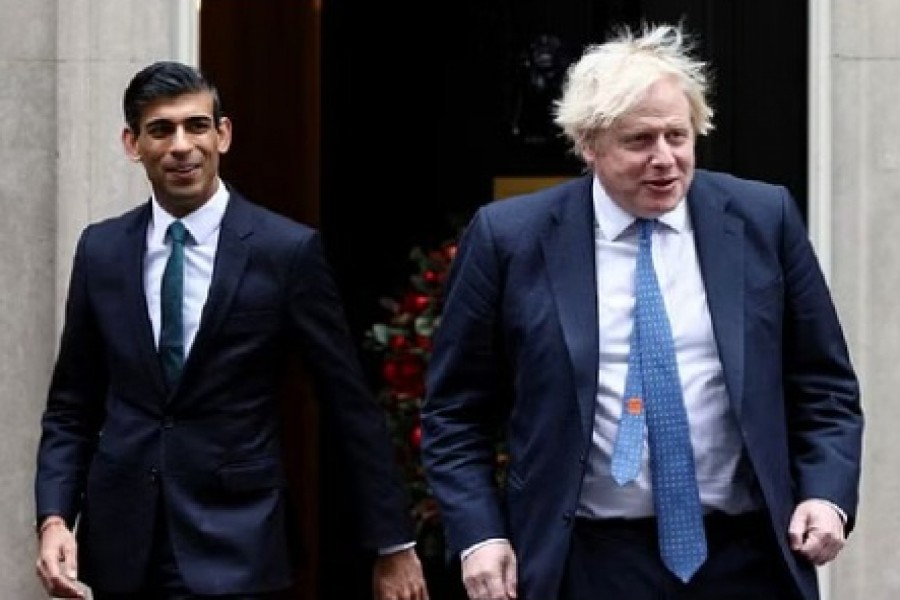 Boris Johnson and Rishi Sunak walk out of Downing Street, in London, Britain, Dec 1, 2021. REUTERS