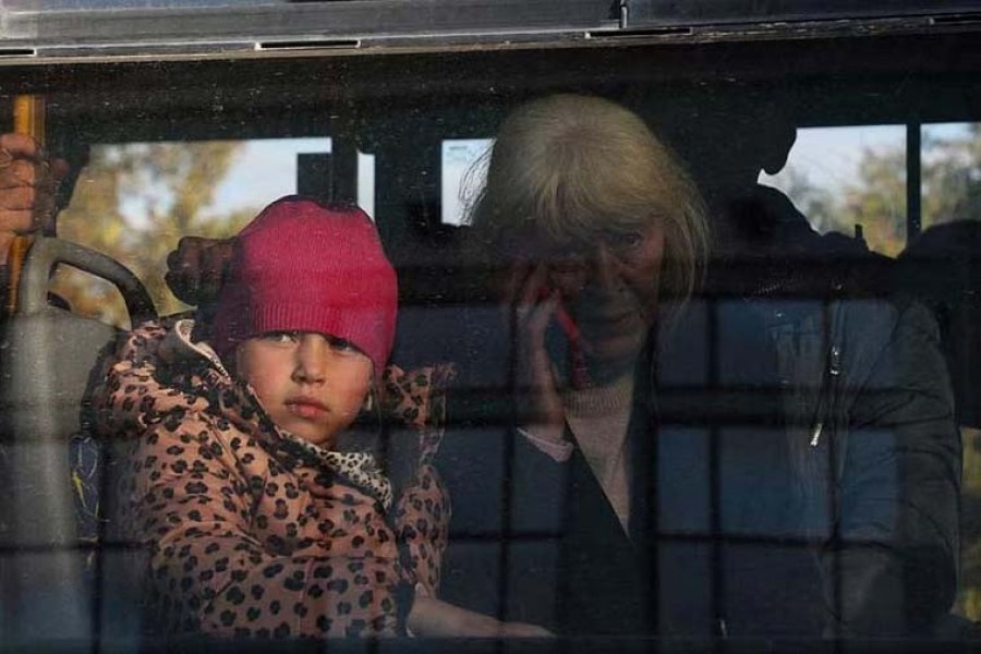 FILE PHOTO - Civilians evacuated from the Russian-controlled Kherson region of Ukraine sit inside a bus upon arrival at a railway station in the town of Dzhankoi, Crimea October 24, 2022. REUTERS/Alexey Pavlishak