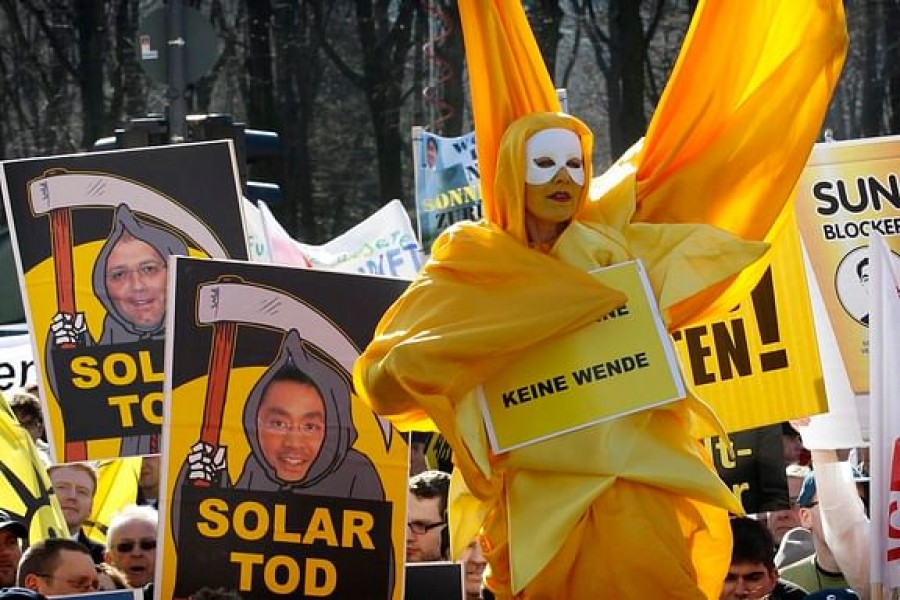 Protesters take part in a demonstration against the German governments planned cuts in solar power incentives, in Berlin March 5, 2012. | REUTERS