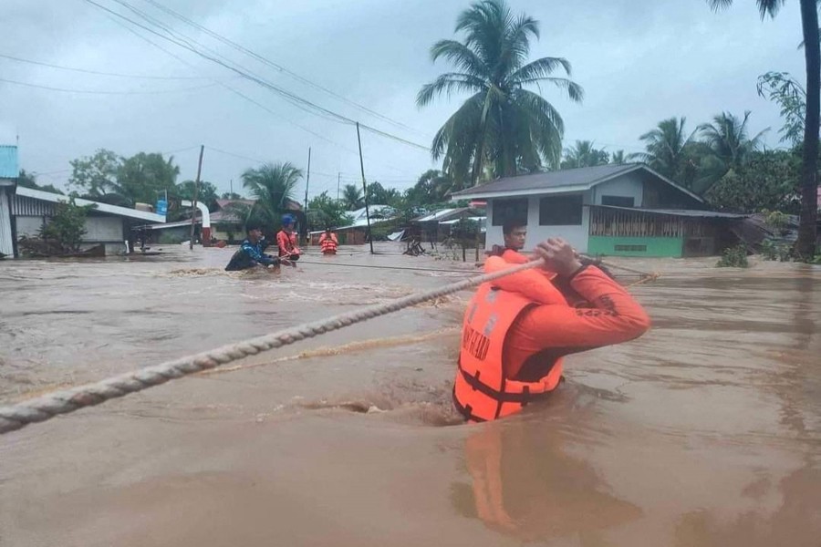 Philippine Coast Guard (PCG) rescuers evacuate residents from their flooded homes due to a tropical storm, locally named Paeng, in Maguindanao province, Philippines on October 28, 2022 — Philippine Coast Guard/Handout via REUTERS