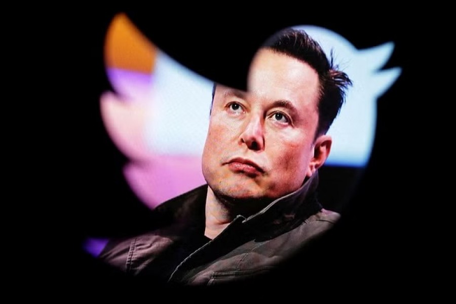 Elon Musk's photo is seen through a Twitter logo in this illustration taken October 28, 2022.REUTERS