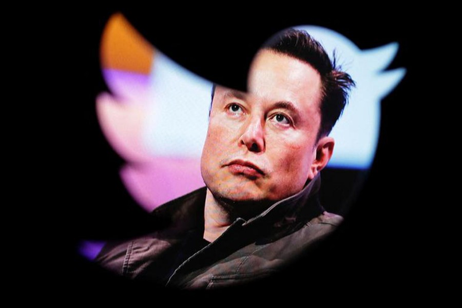 Elon Musk's photo is seen through a Twitter logo in this illustration taken on October 28, 2022 — Reuters/Files