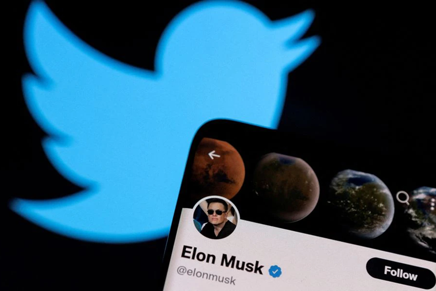 Elon Musk's Twitter account is seen on a smartphone in front of the Twitter logo in this photo illustration taken on April 15, 2022 — Reuters/Files
