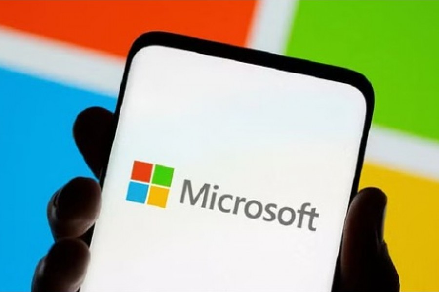 Smartphone is seen in front of Microsoft logo displayed in this illustration taken, Jul 26, 2021. REUTERS