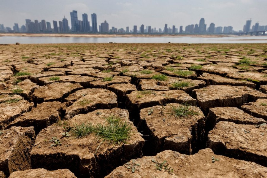 Cracks run through the partially dried-up river bed of the Gan River, a tributary to Poyang Lake during a regional drought in Nanchang, Jiangxi province, China, August 28, 2022. REUTERS/Thomas Peter/File Photo