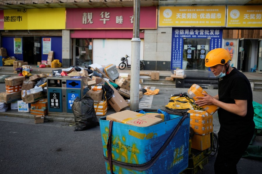 A delivery worker sorts parcels at a makeshift logistics station ahead of Alibaba's Singles' Day shopping festival, following the coronavirus disease (Covid-19) outbreak in Shanghai, China on November 10, 2022 — Reuters photo