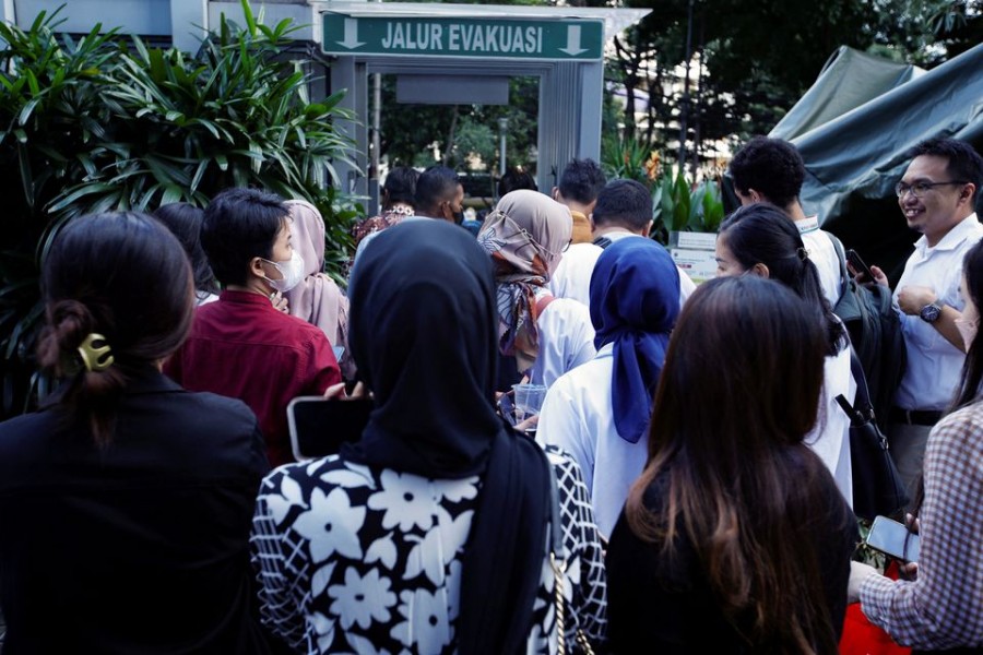 People gather as they are evacuated outside a building following an earthquake in Jakarta, Indonesia on November 21, 2022 — Reuters photo