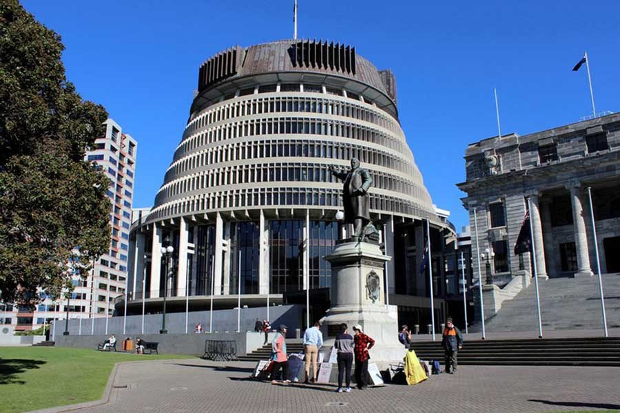 People standing outside the executive wing of the New Zealand Parliament complex in Wellington –Reuters file photo