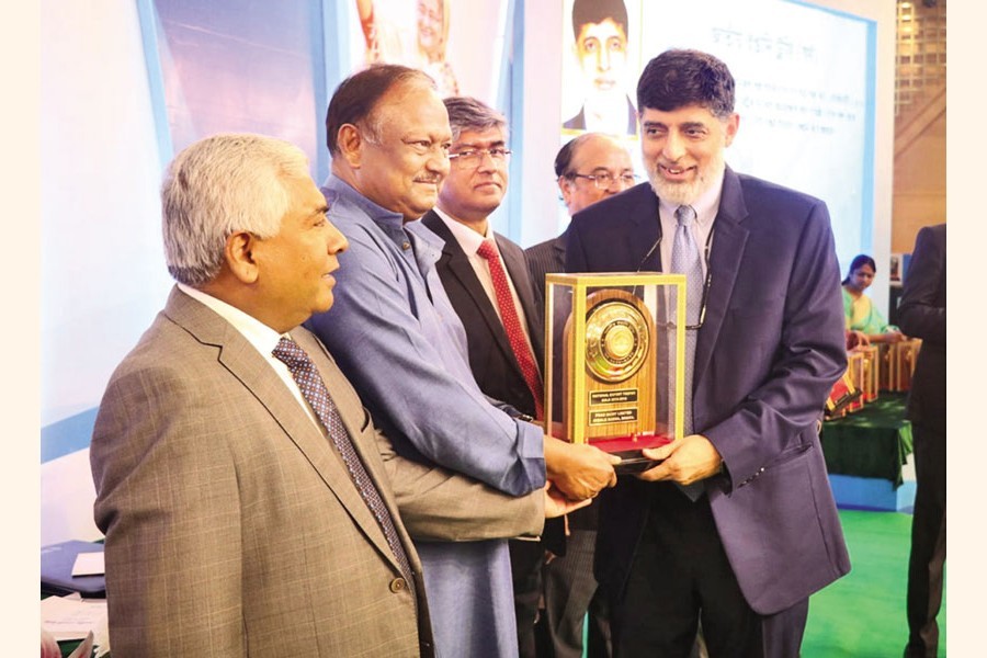 - Ahsan Khan Chowdhury, Chairman and CEO of PRAN-RFL Group, receives the National Export Trophy from Commerce Minister Tipu Munshi at the award giving ceremony in the city on Tuesday