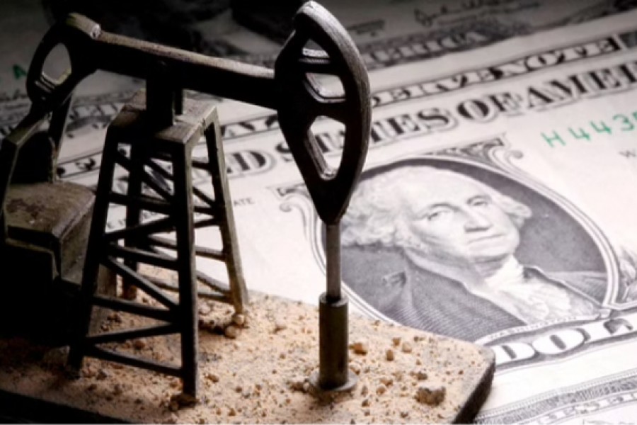 A 3D-printed oil pump jack is placed on dollar banknotes in this illustration picture, Apr 14, 2020. REUTERS