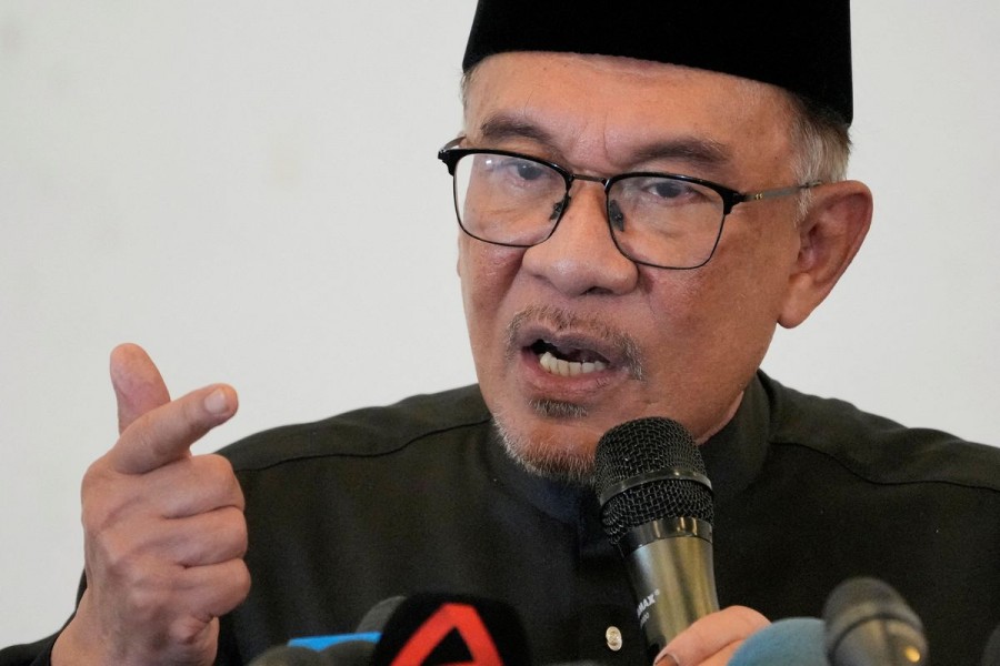 Malaysia's newly appointed Prime Minister Anwar Ibrahim reacts as he deliver his speech during a gathering in Kuala Lumpur, Malaysia November 24, 2022.Vincent Thian/Pool via REUTERS