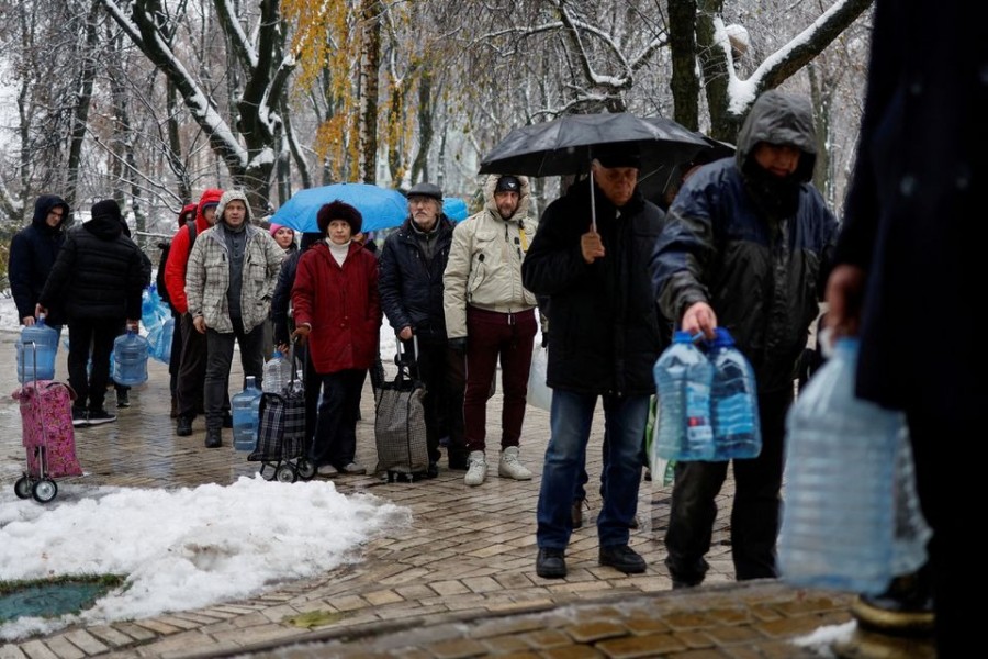 Local residents stand in line to fill up bottles with fresh drinking water after critical civil infrastructure was hit by Russian missile attacks in Kyiv, Ukraine on November 24, 2022 — Reuters photo