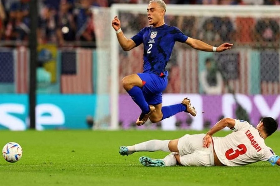 Football - FIFA World Cup Qatar 2022 - Group B - Iran v United States - Al Thumama Stadium, Doha, Qatar - Nov 29, 2022 Sergino Dest of the US in action with Iran's Ehsan Hajsafi. REUTERS