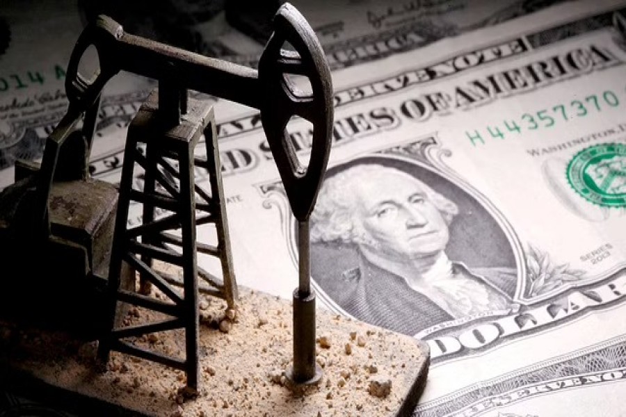 A 3D-printed oil pump jack is placed on dollar banknotes in this illustration picture, Apr 14, 2020. REUTERS