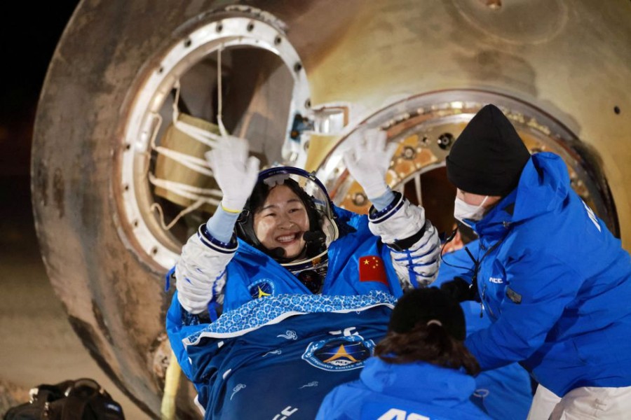 Astronaut Liu Yang waves as she is out of a return capsule of the Shenzhou-14 spacecraft, following a six-month mission on China's space station, at the Dongfeng landing site in Inner Mongolia Autonomous Region, China December 4, 2022. China Daily via REUTERS